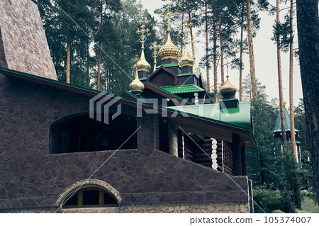 Stone temple in the forest on Ganina Pit - a complex of wooden Orthodox churches at the burial site of the last Russian tsar near Yekaterinburg, Russia, taken 12.06.2022. High quality photo Stone temple in the forest on Ganina Pit - a complex of wooden Orthodox churches at the burial site of the last Russian tsar near Yekaterinburg, Russia, taken 12.06.2022. High quality photo 105374007