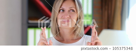 Caucasian woman with emotions of hope on her face stands and gesticulates with crossed fingers. Caucasian woman with emotions of hope on her face stands and gesticulates with crossed fingers. 105375348