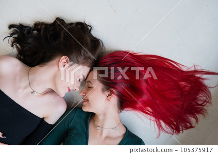 Top view of two women lying side by side. Lesbian intimacy. 105375917