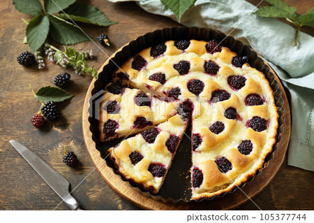 Homemade blackberry pie. Vegan gluten-free pastry, vegan desserts. Sweet pie with blackberry and custard on wooden table. 105377744