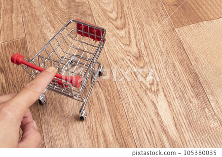 Small decorative cart on a wooden background Small decorative cart on a wooden background 105380035