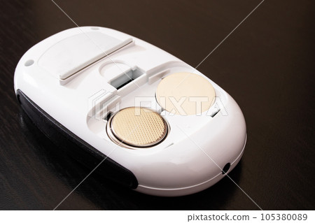 Battery connector in electronic device on wooden background 105380089