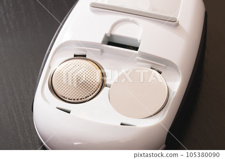 Battery connector in electronic device on wooden background 105380090