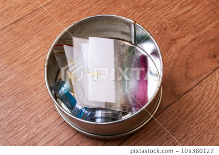 Sequins for needlework in bags on the table 105380127