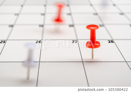 Pushpins on calendar. Business management event, business plan targeted marketing activities. Embroidered pins on calendar event. Planner calendar, planning. 105380422