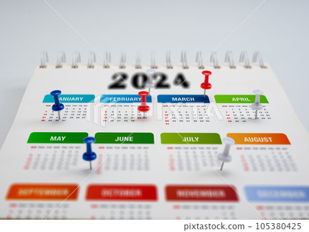 2024 Calendar planning. colorful pin thumbtack date on calendar or planner. 2024 planning and scheduling or event reminder concept. pins on calendar event 105380425