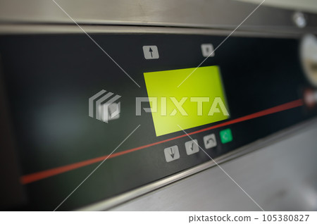 Industrial laundry machine display in a public laundromat. Industrial laundry machine display in a public laundromat. 105380827