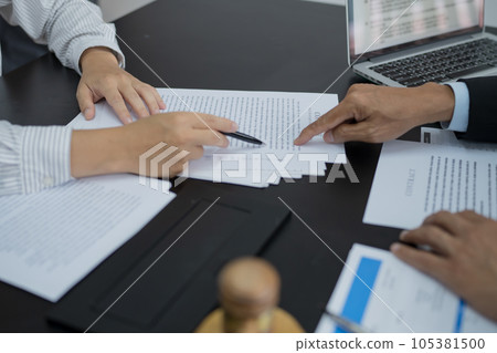 Legal counsel presents to the client a signed contract with gavel and legal law. justice and lawyer concept 105381500