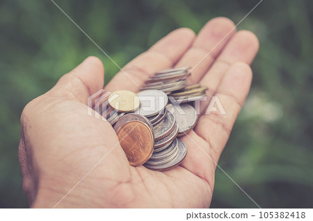 Close up coin in hand Close up coin in hand 105382418