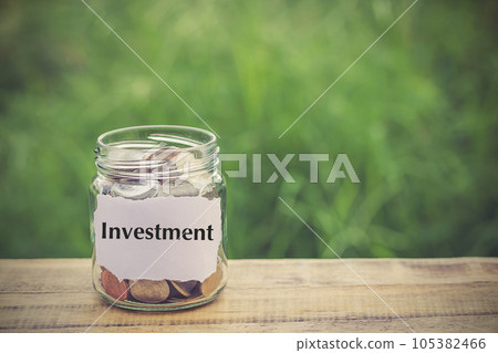 Money in the jar on wooden table Money in the jar on wooden table 105382466