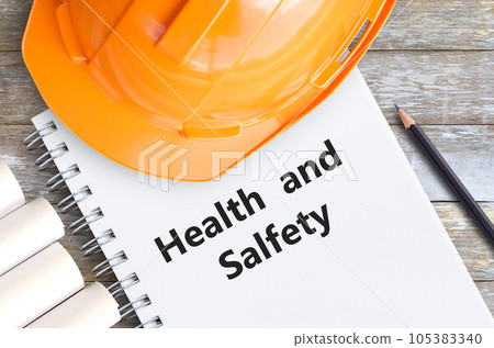 Health and safety with orange helmet,pencil and notebooks 105383340