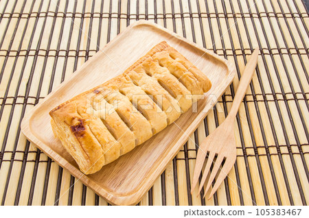 Pineapple pie in wooden plate on wooden background Pineapple pie in wooden plate on wooden background 105383467
