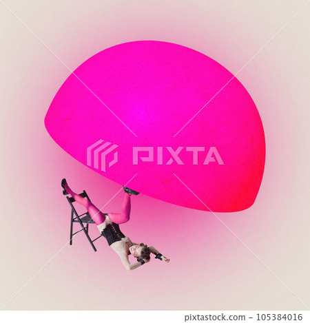 Young woman lies on floor with one leg leaning on chair and othe holding 3d neon pink hemisphere over pastel beige background. 105384016