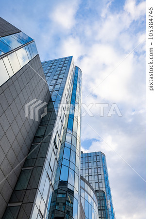 Bottom view of modern skyscrapers in business district against blue sky Bottom view of modern skyscrapers in business district against blue sky 105384746