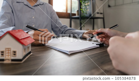Real estate broker agent presenting and consult to customer to decision making sign insurance form agreement, home model, concerning mortgage loan offer for and house insurance Real estate broker agent presenting and consult to customer to decision making sign insurance form agreement, home model, concerning mortgage loan offer for and house insurance 105384878