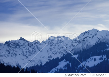 Mountain with snow. Alps. Switzerland. Panoramic view of the Snowy Alps and blue sky around the Titlis mountain. French Alps. Alpine mountains. Descent peaks on the Austrian snow slopes. ski slopes. Mountain with snow. Alps. Switzerland. Panoramic view of the Snowy Alps and blue sky around the Titlis mountain. French Alps. Alpine mountains. Descent peaks on the Austrian snow slopes. ski slopes. 105385543