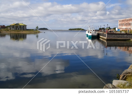 picturesque view of pier on Solovki. Blurred background. Reflections in water 105385737