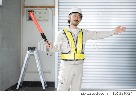 With safety vests, such as security guards guiding in the warehouse With safety vests, such as security guards guiding in the warehouse 105386724