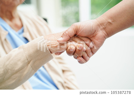 Doctor holding hands Asian elderly woman patient, help and care in hospital. 105387278