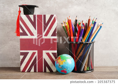 Bangkok, Thailand April 1, 2023 English book and piggy bank with globe, learning and tutorial for foreigner. Bangkok, Thailand April 1, 2023 English book and piggy bank with globe, learning and tutorial for foreigner. 105387375