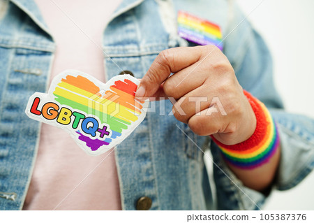Asian woman with rainbow flag, LGBT symbol rights and gender equality, LGBT Pride Month in June. Asian woman with rainbow flag, LGBT symbol rights and gender equality, LGBT Pride Month in June. 105387376
