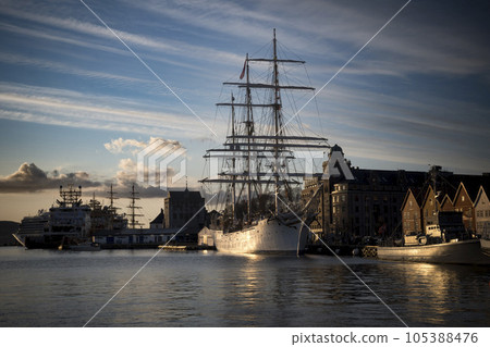 Sailing ship docked in Bergen harbour in golden sunlight 105388476