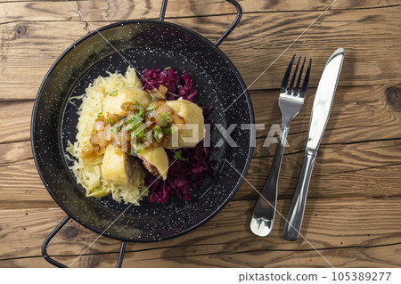 dumpllings filled with smoked meat served with red and white cabbage dumpllings filled with smoked meat served with red and white cabbage 105389277