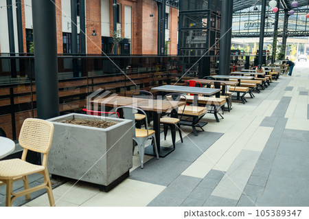 Cafe interior design. Interior design style, wooden tables and chairs Cafe interior design. Interior design style, wooden tables and chairs 105389347