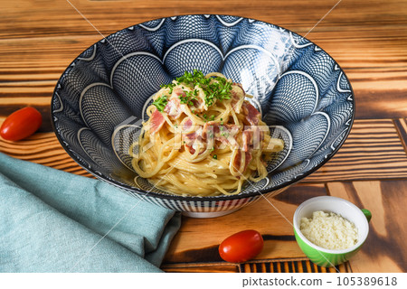 Pasta carbonara with bacon and cheese close up side view Pasta carbonara with bacon and cheese close up side view 105389618