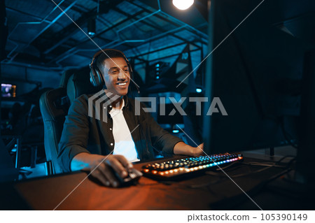 Portrait of a happy computer gamer in headphones. Portrait of a happy computer gamer in headphones. 105390149