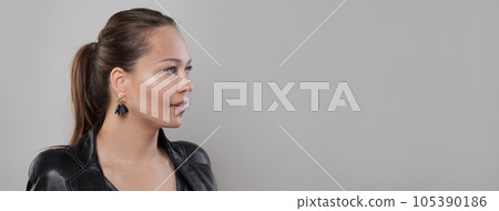 Beautiful woman fashion model in jewelry earring on grey banner background with copy space Beautiful woman fashion model in jewelry earring on grey banner background with copy space 105390186