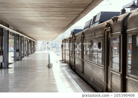Empty train station and an old train standing on the rails 105390406