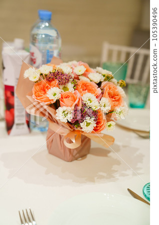 Bouquet of flowers on the served table.  105390496