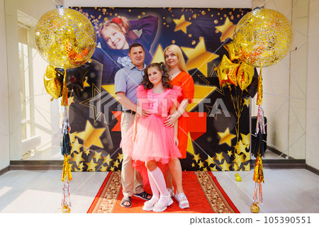 parents with Beautiful teenage daughter in a pink dress for pop star parties. parents with Beautiful teenage daughter in a pink dress for pop star parties. 105390551