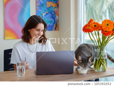 woman using laptop while working indoors woman using laptop while working indoors 105391052