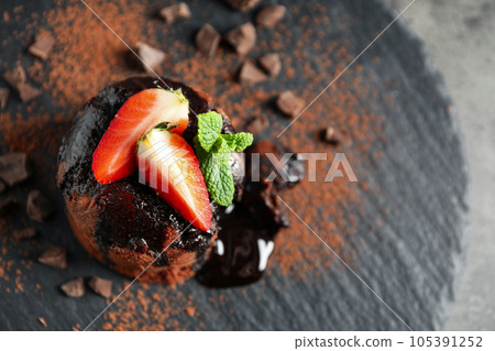 Delicious warm chocolate lava cake on slate board, above view. Space for text Delicious warm chocolate lava cake on slate board, above view. Space for text 105391252