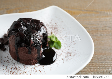 Delicious warm chocolate lava cake on plate, closeup Delicious warm chocolate lava cake on plate, closeup 105391258