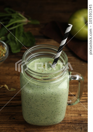 Tasty green buckwheat smoothie on wooden table 105391345