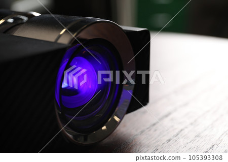 Closeup view of modern digital video projector on table 105393308