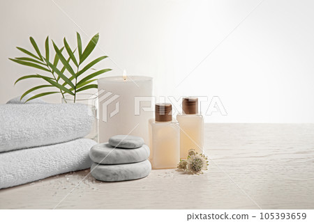 Composition with spa stones on white wooden table. Space for text 105393659