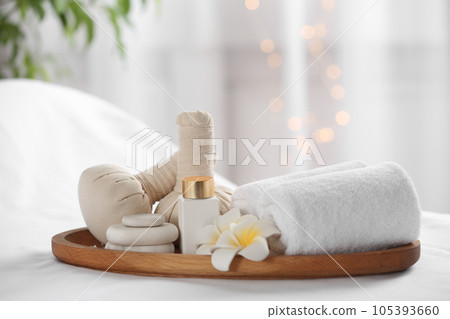 Beautiful composition with spa stones on white fabric Beautiful composition with spa stones on white fabric 105393660