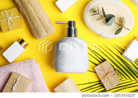 Flat lay composition with marble soap dispenser on yellow background Flat lay composition with marble soap dispenser on yellow background 105393820