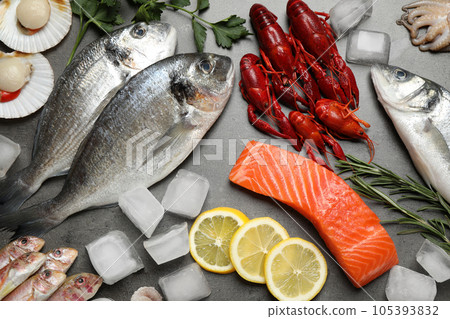 Fresh fish and seafood on grey table, flat lay 105393832