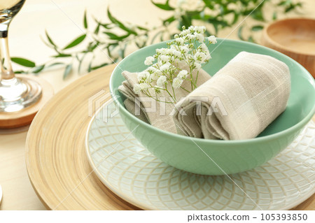 Elegant table setting with flowers and leaves, closeup Elegant table setting with flowers and leaves, closeup 105393850