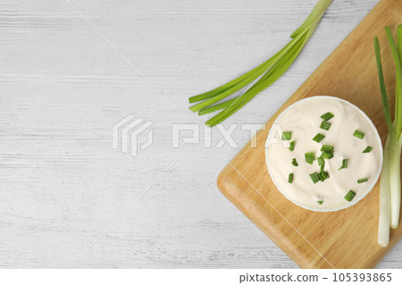 Fresh sour cream with onion on white wooden table, flat lay. Space for text Fresh sour cream with onion on white wooden table, flat lay. Space for text 105393865