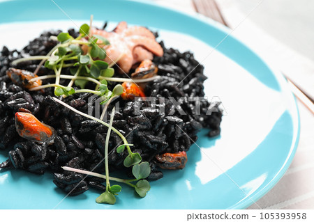 Delicious black risotto with seafood in plate, closeup Delicious black risotto with seafood in plate, closeup 105393958