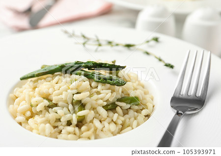 Delicious risotto with asparagus in plate, closeup 105393971