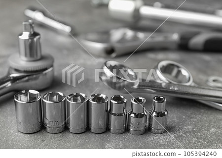 Auto mechanic's tools on grey stone table 105394240