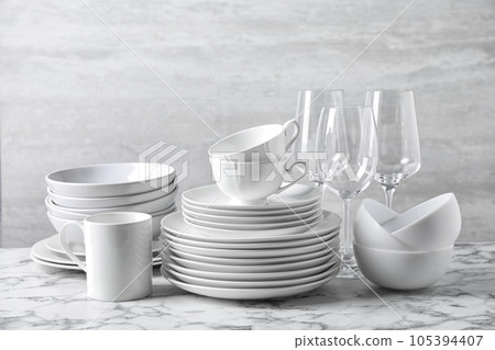 Set of clean dishware on marble table 105394407