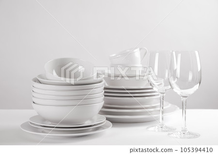Set of clean dishes on white table 105394410